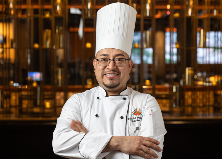 a man wearing a chefs hat and glasses
